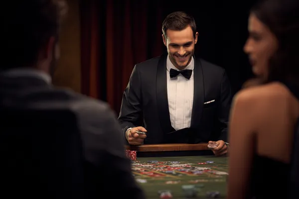 A woman in a luxurious green gown next to an ornate roulette wheel, capturing the upscale casino mood of 7000BET.